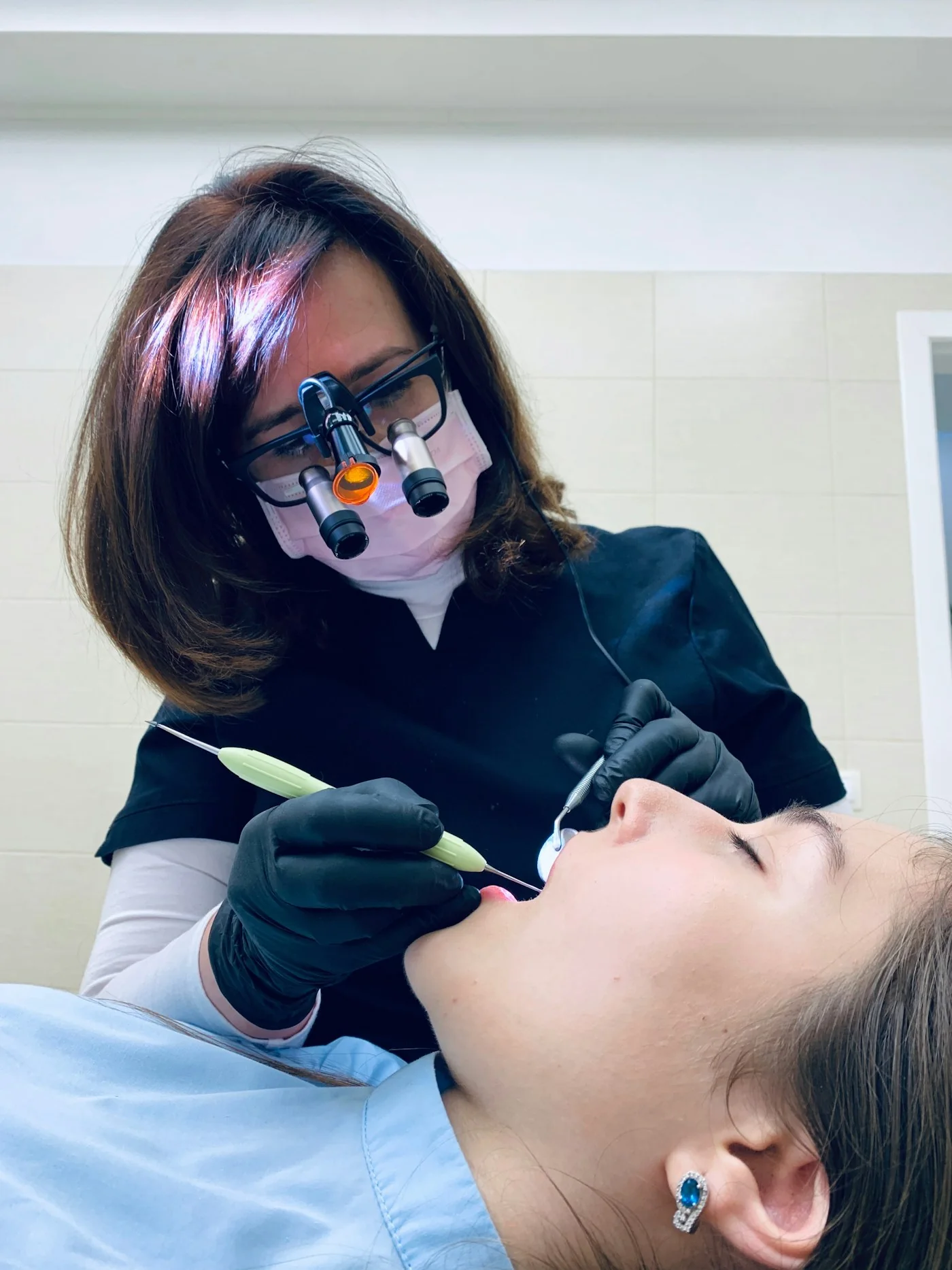 A dentist performing focused treatment on a patient