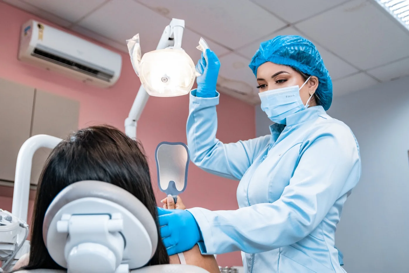 A patient having their teeth checked by a dentist
